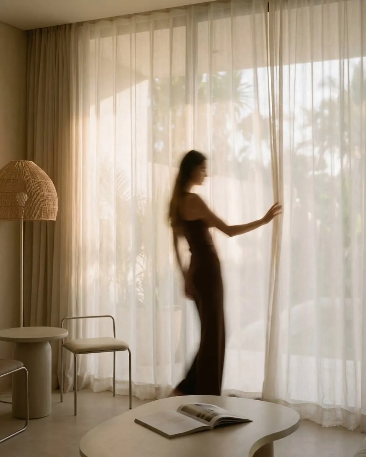Sheer curtains drawn back from a window onto the garden
