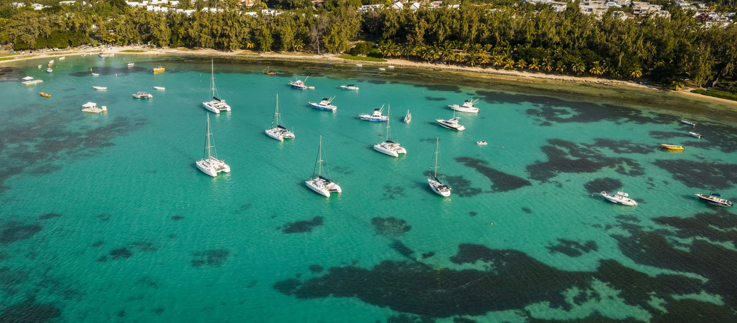 Aerial view of the lagoon at Bain Boeuf, Mauritius, with boats at anchor over turquoise water