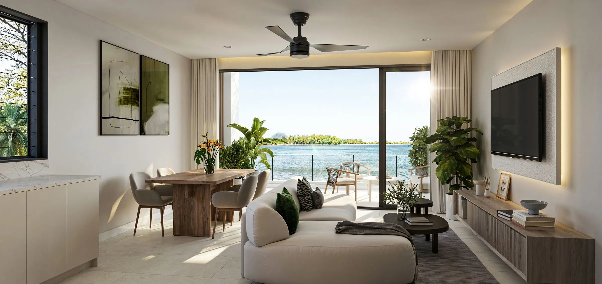 Living and dining space opening onto a terrace with a view of the lagoon